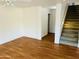 Open-plan living room with stairs to the second floor and wood-look flooring at 6727 E Stacy St, Florence, AZ 85132