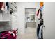 Organized walk-in closet with custom shelving and storage solutions and a view into a full bathroom at 7180 E Kierland Blvd # 508, Scottsdale, AZ 85254