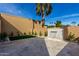 Backyard features travertine flooring, a small grassy area, palms and a water feature at 7318 E Palo Verde Dr # 7, Scottsdale, AZ 85250