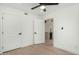 Bedroom featuring light wood floors, open doorway to kitchen, ceiling fan and modern doors at 7318 E Palo Verde Dr # 7, Scottsdale, AZ 85250