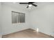 Bright bedroom with light wood floors, a ceiling fan and a large window at 7318 E Palo Verde Dr # 7, Scottsdale, AZ 85250