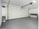 Spacious garage with epoxy floor, a large door, and storage shelving at 7318 E Palo Verde Dr # 7, Scottsdale, AZ 85250