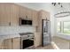 Bright, modern kitchen featuring stainless steel appliances and light wood cabinetry at 7318 E Palo Verde Dr # 7, Scottsdale, AZ 85250