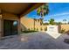 Covered patio with travertine flooring, a grassy area, and a water feature at 7318 E Palo Verde Dr # 7, Scottsdale, AZ 85250