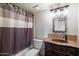 This bathroom showcases a charming vanity, granite countertop, unique mirror and shower/tub combination at 8165 E Del Marino Dr, Scottsdale, AZ 85258