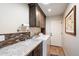 Laundry room with front load washer and dryer, sink, granite countertop and tiled backsplash with plenty of storage at 8165 E Del Marino Dr, Scottsdale, AZ 85258