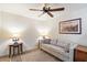 This quiet room features a neutral color palette, comfy sofa, accent tables, lamps, and a decorative area rug at 8165 E Del Marino Dr, Scottsdale, AZ 85258