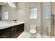 Modern bathroom with a walk-in shower, floating vanity, and sleek fixtures at 9467 E Rockwood Dr, Scottsdale, AZ 85255