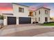 Elegant two-story home boasting a three-car garage, tile roof, and manicured landscaping at 9467 E Rockwood Dr, Scottsdale, AZ 85255