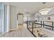 Spacious hallway with modern railing and tile floors, filled with natural light from large windows at 9467 E Rockwood Dr, Scottsdale, AZ 85255