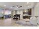 Chic living area featuring a baby grand piano, a bar, and a sliding glass door with balcony access at 9467 E Rockwood Dr, Scottsdale, AZ 85255