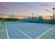 Community tennis court with mature trees, lighting and perimeter fencing at 9467 E Rockwood Dr, Scottsdale, AZ 85255