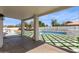 The backyard features pavers, turf, a pool, and an outdoor kitchen, perfect for entertaining at 951 N Poinciana Rd, Gilbert, AZ 85234