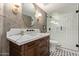 Stylish bathroom with a marble countertop, modern fixtures, and a glass-enclosed shower with sleek hardware at 951 N Poinciana Rd, Gilbert, AZ 85234