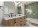 Stylish bathroom featuring double vanity, elegant mirrors, and shower with glass doors at 951 N Poinciana Rd, Gilbert, AZ 85234