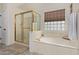 Bathroom with a soaking tub, a separate shower, and modern fixtures at 951 N Poinciana Rd, Gilbert, AZ 85234