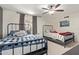 Cozy bedroom featuring two twin beds, a window with white shutters, and carpet floors at 951 N Poinciana Rd, Gilbert, AZ 85234