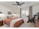 Cozy bedroom featuring a neutral color palette, a ceiling fan, and a bright window with plush carpeting at 951 N Poinciana Rd, Gilbert, AZ 85234