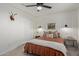 This bedroom features paneled walls, a ceiling fan, and a bright window creating a comfortable atmosphere at 951 N Poinciana Rd, Gilbert, AZ 85234