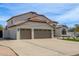 Charming two-story home featuring a three-car garage, manicured lawn, and beautiful desert landscaping at 951 N Poinciana Rd, Gilbert, AZ 85234