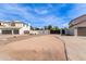 View of driveway area in a neighborhood with mature landscaping and privacy gates at 951 N Poinciana Rd, Gilbert, AZ 85234