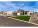 Charming two-story home featuring a three-car garage, manicured lawn, and beautiful desert landscaping at 951 N Poinciana Rd, Gilbert, AZ 85234