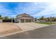 Charming two-story home featuring a three-car garage, manicured lawn, and beautiful desert landscaping at 951 N Poinciana Rd, Gilbert, AZ 85234