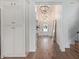 Bright foyer with hardwood floors, white walls, and stylish chandeliers leading to the front door at 951 N Poinciana Rd, Gilbert, AZ 85234