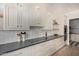 A modern kitchen showcases white cabinets, black countertops, and a sleek cooktop at 951 N Poinciana Rd, Gilbert, AZ 85234