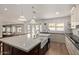 Bright kitchen with a farmhouse sink, an oversized island, and stainless steel appliances at 951 N Poinciana Rd, Gilbert, AZ 85234