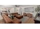 Living room featuring a brown leather sofa, ceiling fan, and view to the kitchen at 951 N Poinciana Rd, Gilbert, AZ 85234