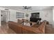 Spacious living room with brown leather sofa, ceiling fan, and dark wood entertainment center at 951 N Poinciana Rd, Gilbert, AZ 85234