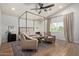 A serene main bedroom with a four-poster bed, ceiling fan, and natural light at 951 N Poinciana Rd, Gilbert, AZ 85234