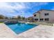 A sparkling in-ground pool is surrounded by a grass and tile backyard at 951 N Poinciana Rd, Gilbert, AZ 85234