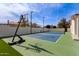 Full sport court including basketball hoop and tennis net at 951 N Poinciana Rd, Gilbert, AZ 85234