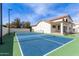 A full sport court is complete with basketball hoop and tennis net at 951 N Poinciana Rd, Gilbert, AZ 85234