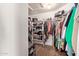 Organized walk-in closet with shelves and hanging space for clothes and accessories on hardwood floors at 951 N Poinciana Rd, Gilbert, AZ 85234