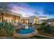 Lush backyard featuring a large pool, covered patio, outdoor seating, and desert sunset views at 10029 E Calle De Las Brisas --, Scottsdale, AZ 85255