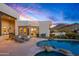 Desert backyard with a pool, spa, flagstone patio, lounge chairs, and mountain views at 10029 E Calle De Las Brisas --, Scottsdale, AZ 85255