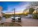 Relaxing backyard with lounge chairs, desert landscaping, pool, spa, and views of the sunset at 10029 E Calle De Las Brisas --, Scottsdale, AZ 85255