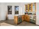 This bar area features two beverage refrigerators, white marble countertops, a wood cabinets, and glass shelves at 10029 E Calle De Las Brisas --, Scottsdale, AZ 85255