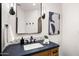 Stylish bathroom featuring a black framed mirror, black fixtures, and artistic wall decor at 10029 E Calle De Las Brisas --, Scottsdale, AZ 85255