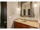 Elegant bathroom with a decorative mirror, granite countertop, and stylish fixtures at 10029 E Calle De Las Brisas --, Scottsdale, AZ 85255