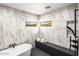 A luxurious bathroom showcasing marble walls, modern fixtures, and a sleek bathtub with a view at 10029 E Calle De Las Brisas --, Scottsdale, AZ 85255