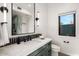 Modern bathroom features dark green vanity, marble countertop, and views through a window at 10029 E Calle De Las Brisas --, Scottsdale, AZ 85255