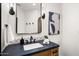 Modern bathroom featuring black fixtures, a white sink, a black framed mirror and contemporary decor at 10029 E Calle De Las Brisas --, Scottsdale, AZ 85255