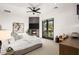 This bedroom features a fireplace, doors to the patio, and is decorated with neutral colored décor at 10029 E Calle De Las Brisas --, Scottsdale, AZ 85255
