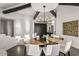 The dining room features stylish chandelier, large wood table, seating for eight and backyard views at 10029 E Calle De Las Brisas --, Scottsdale, AZ 85255