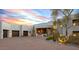 Desert home with a paved driveway, three-car garage, and drought-resistant landscaping at 10029 E Calle De Las Brisas --, Scottsdale, AZ 85255