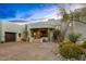 Desert home with an exposed aggregate driveway and xeriscaping leading to a covered entrance at 10029 E Calle De Las Brisas --, Scottsdale, AZ 85255